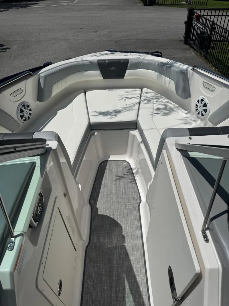 Slide: The Image of 2022 Chaparral 21 SSi boat interior with white seating and gray flooring. - 6
