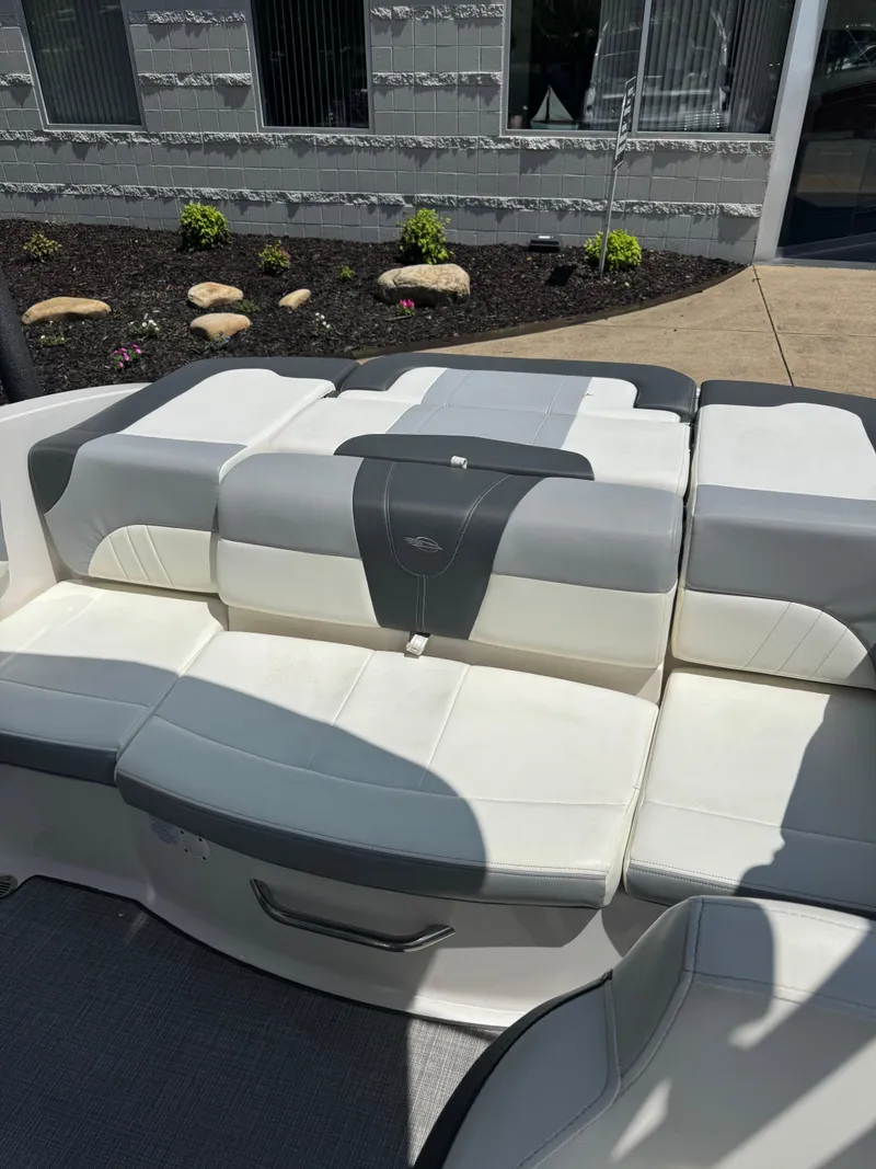 Slide: The Image of 2022 Chaparral 21 SSi boat interior with white and gray seating. - 2