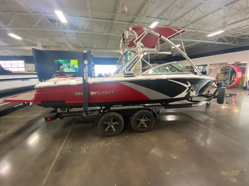 Slide: The Image of 2011 MasterCraft X14 boat displayed indoors on a trailer. - 18