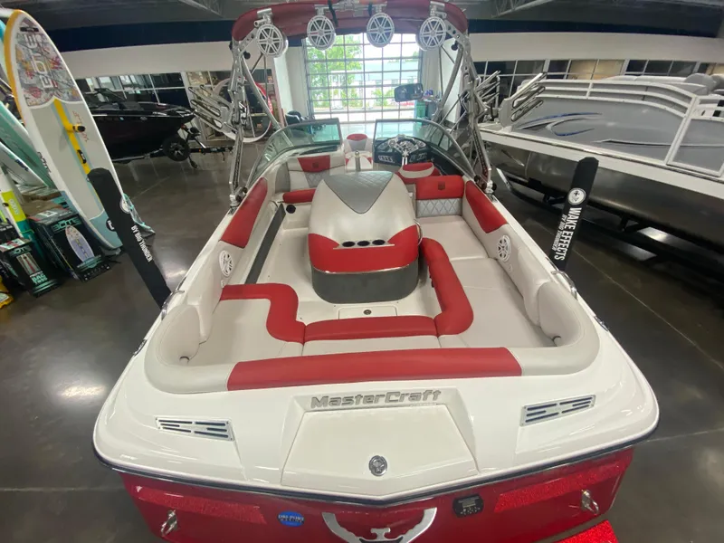 Slide: The Image of 2011 MasterCraft X14 boat with red and white interior, displayed indoors. - 21