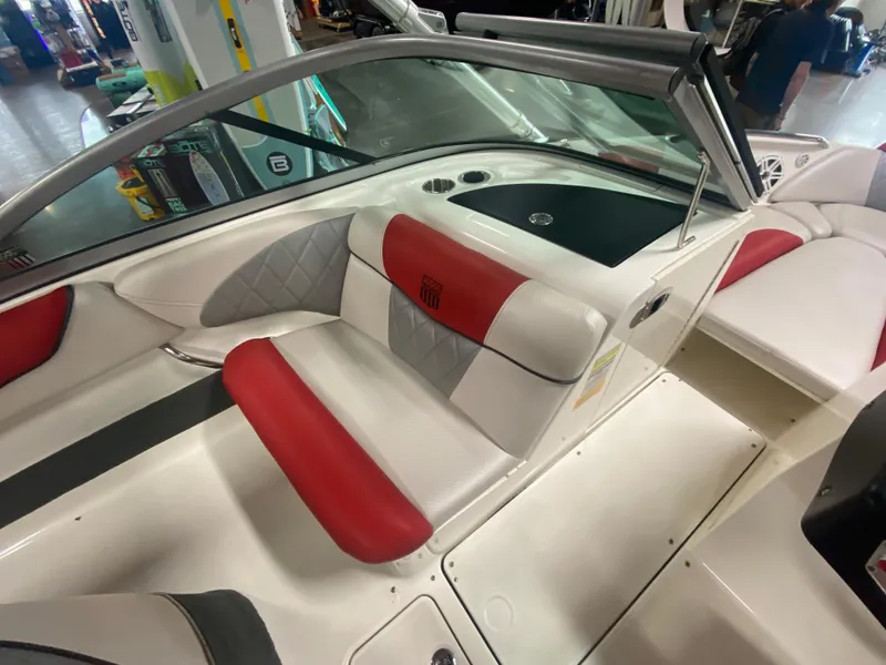 Slide: The Image of 2011 MasterCraft X14 boat interior with red and white seating, sleek design. - 24