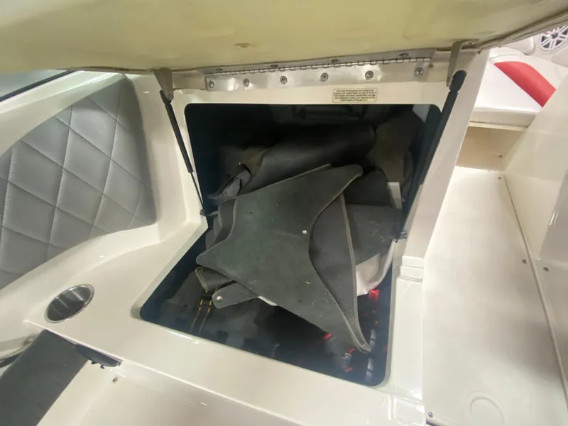 Slide: The Image of Open storage compartment in 2011 MasterCraft X14 boat, showing interior space and materials. - 25