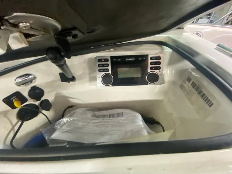 Slide: The Image of 2011 MasterCraft X14 boat dashboard with Clarion stereo system and storage compartment. - 26