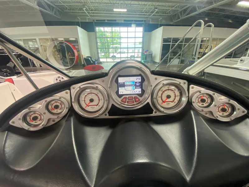 Slide: The Image of Dashboard of a 2011 MasterCraft X14 boat with multiple gauges and digital display. - 30