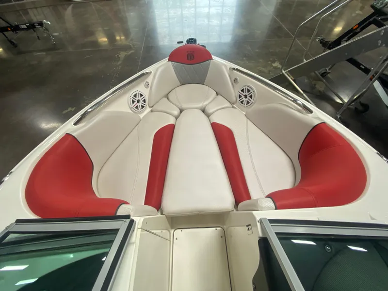 Slide: The Image of 2011 MasterCraft X14 boat interior with red and white seating, featuring built-in speakers. - 32