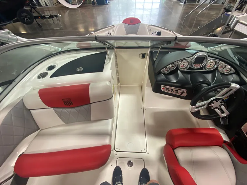 Slide: The Image of 2011 MasterCraft X14 boat interior with red and white seating, dashboard, and steering wheel. - 33