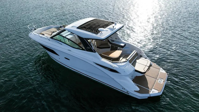 Slide: The Image of 2024 Sea Ray Sundancer 320 yacht cruising on open water, showcasing sleek design and luxury features. - 1