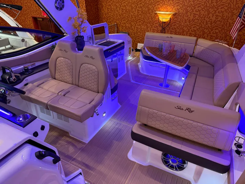 Slide: The Image of 2024 Sea Ray Sundancer 320 interior with luxurious seating and ambient lighting. - 10