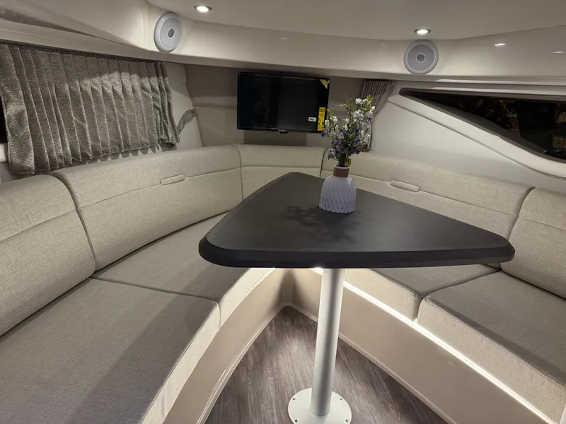 Slide: The Image of 2024 Sea Ray Sundancer 320 interior with elegant seating and table arrangement. - 13