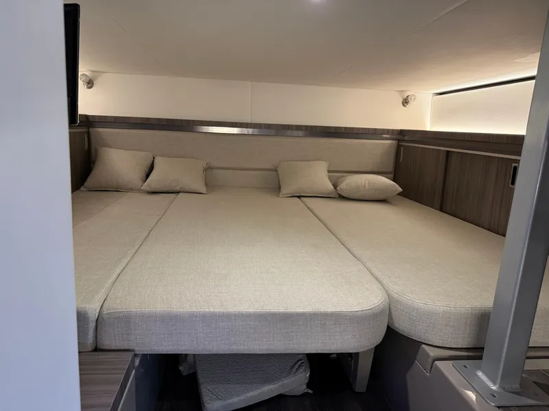 Slide: The Image of 2024 Sea Ray Sundancer 320 cabin with spacious bed and modern design. - 14