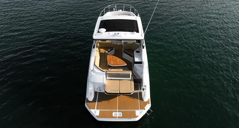 Slide: The Image of 2024 Sea Ray Sundancer 320 yacht on water, aerial view, showcasing deck and seating area. - 3