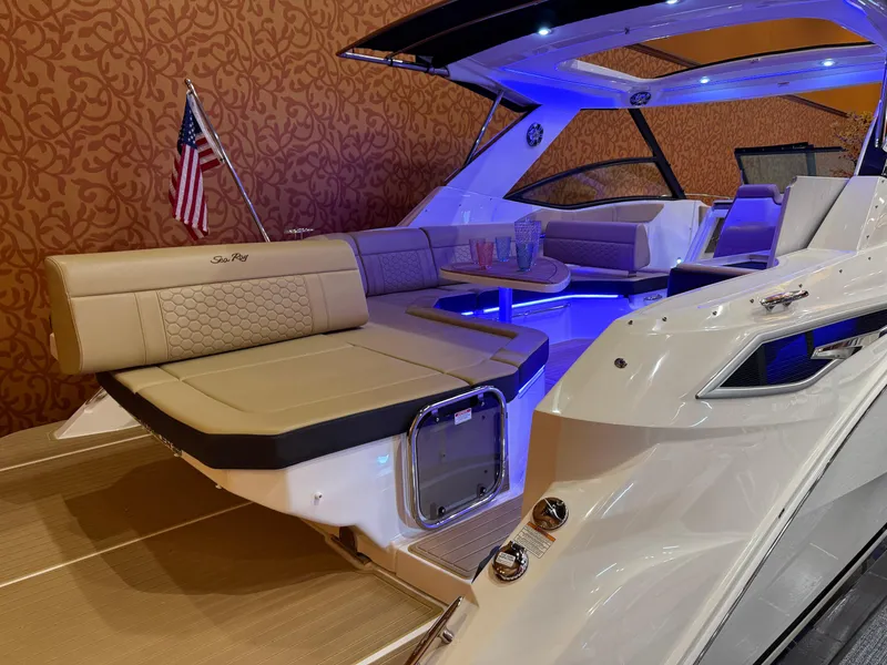 Slide: The Image of 2024 Sea Ray Sundancer 320 yacht interior with seating, table, and ambient lighting. - 5