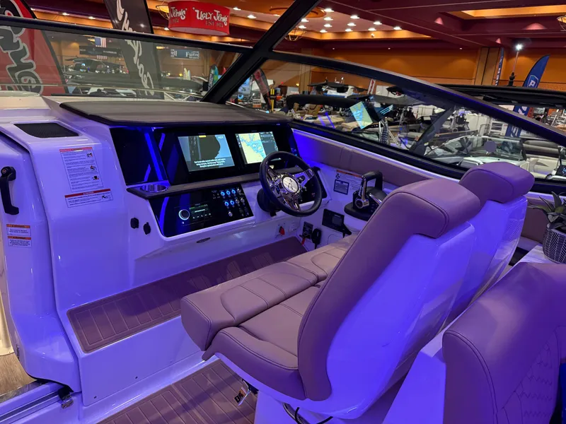 Slide: The Image of 2024 Sea Ray Sundancer 320 cockpit with modern controls and illuminated dashboard. - 8