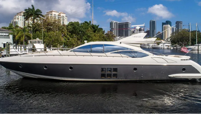 The Image of Luxury 2005 Azimut 68S yacht docked in a marina with city skyline backdrop. - 0