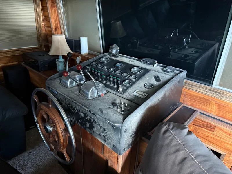 Slide: The Image of Vintage 1980 Harbor Master 47 boat control panel with wooden accents and steering wheel. - 11