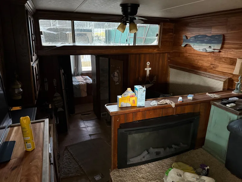 Slide: The Image of Interior of a 1980 Harbor Master 47 boat with wood paneling and nautical decor. - 13