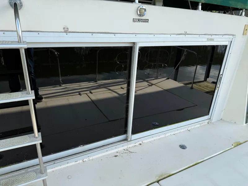 Slide: The Image of 1980 Harbor Master 47 boat with reflective windows and metal ladder. - 17