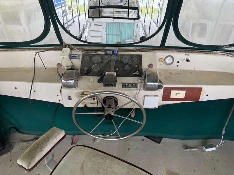 Slide: The Image of Cockpit of 1980 Harbor Master 47 boat with steering wheel and control panel. - 19