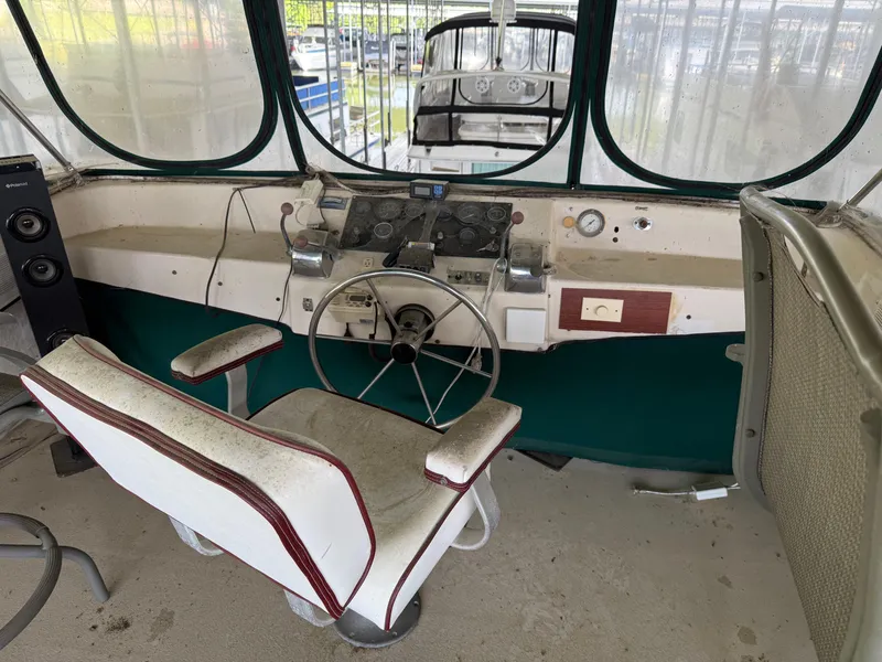 Slide: The Image of 1980 Harbor Master 47 boat helm with vintage steering wheel and control panel. - 20