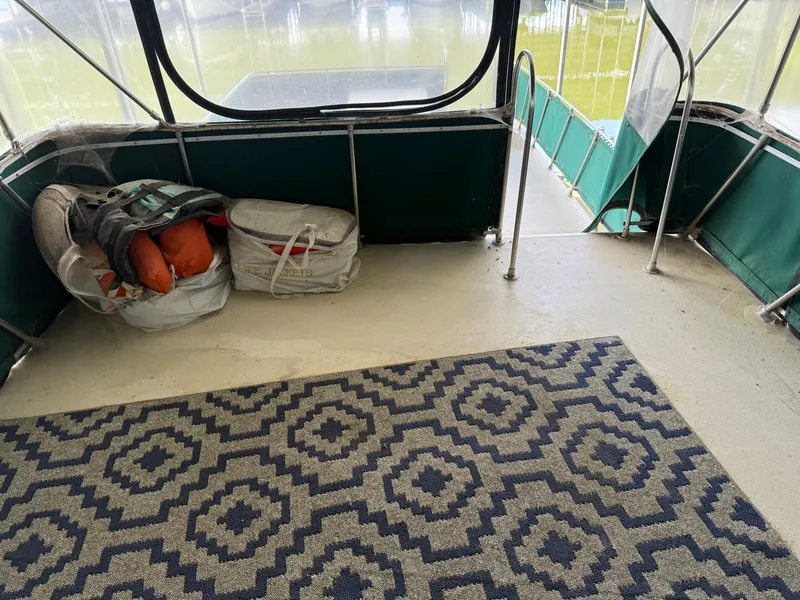 Slide: The Image of 1980 Harbor Master 47 boat interior with patterned rug and life jackets. - 21