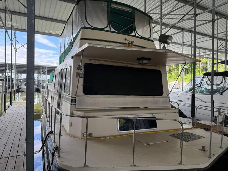Slide: The Image of 1980 Harbor Master 47 houseboat docked in a covered marina. - 4