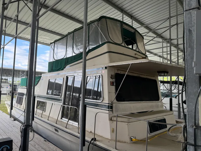 Slide: The Image of 1980 Harbor Master 47 houseboat docked under a covered marina. - 5