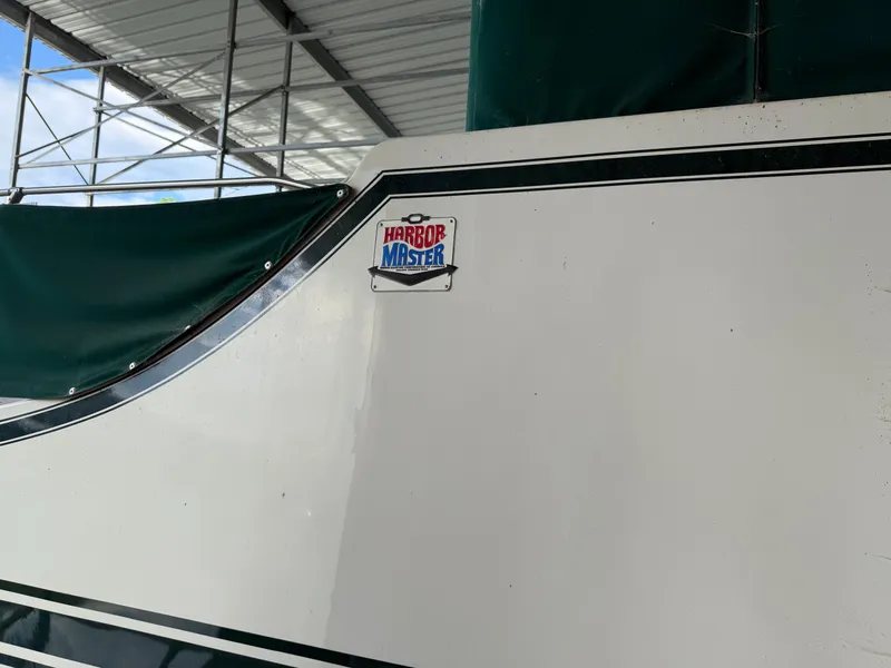 Slide: The Image of 1980 Harbor Master 47 boat side view with logo under covered dock. - 6