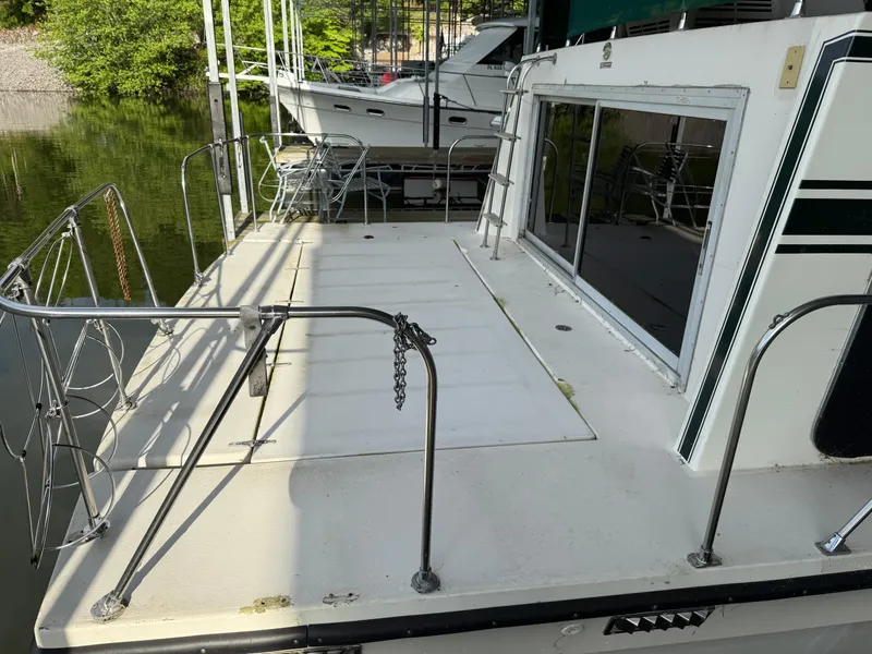 Slide: The Image of 1980 Harbor Master 47 boat deck with railing, docked near water. - 7