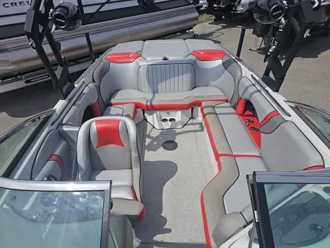 Slide: The Image of 2023 Sanger V237 SX boat interior with gray and red seating, open layout. - 10
