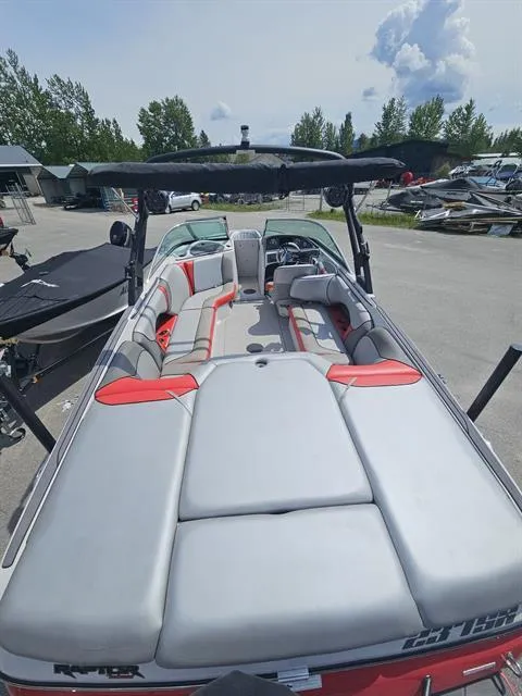 Slide: The Image of 2023 Sanger V237 SX boat with spacious seating and sleek design, parked outdoors. - 16