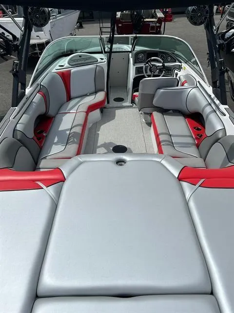 Slide: The Image of 2023 Sanger V237 SX boat interior with gray and red seating, modern dashboard, and spacious layout. - 17