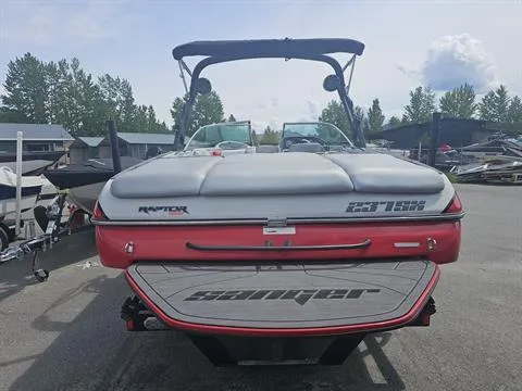 Slide: The Image of 2023 Sanger V237 SX boat, rear view, parked outdoors, featuring Raptor engine. - 18