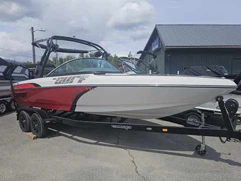 Slide: The Image of 2023 Sanger V237 SX boat on trailer, red and white design, parked outdoors. - 2