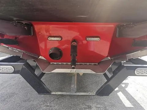Slide: The Image of Rear view of 2023 Sanger V237 SX boat, featuring red hull and trailer. - 20