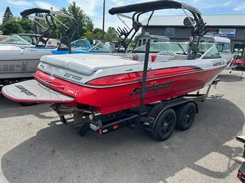 Slide: The Image of 2023 Sanger V237 SX boat in red, parked on a trailer at a dealership. - 4