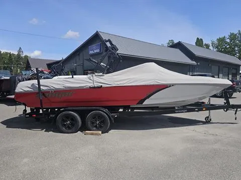 Slide: The Image of 2023 Sanger V237 SX boat covered on a trailer, parked outdoors. - 5
