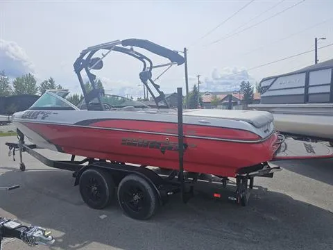 Slide: The Image of 2023 Sanger V237 SX boat in red on a trailer, parked outdoors. - 6