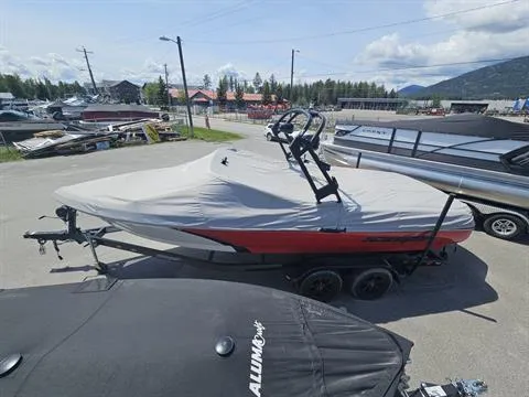 Slide: The Image of 2023 Sanger V237 SX boat covered, parked on trailer in marina lot. - 7