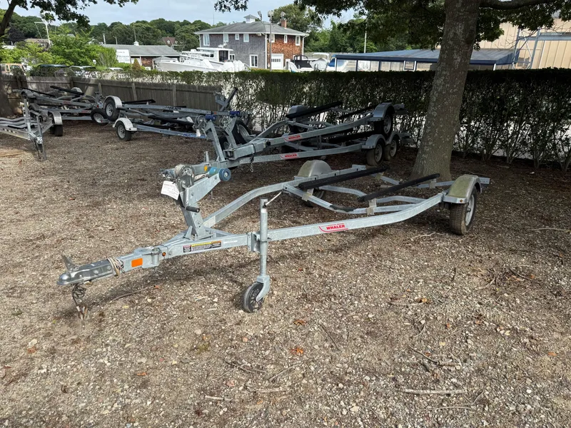 Slide: The Image of Boat trailer for 2016 Boston Whaler 150 Super Sport, parked outdoors. - 11