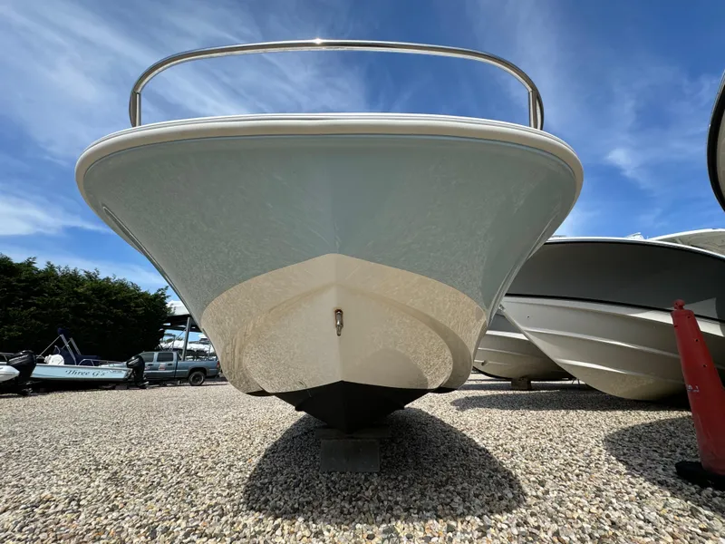 Slide: The Image of 2016 Boston Whaler 150 Super Sport boat on gravel, under clear blue sky. - 9