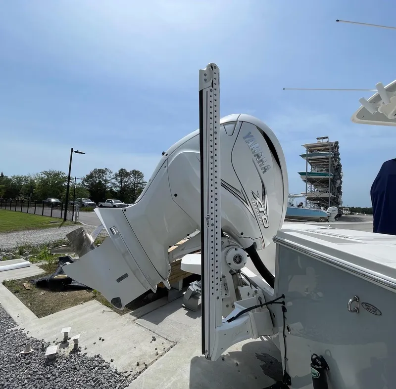 Slide: The Image of 2021 Regulator 26XO boat engine and power pole in a marina setting. - 10