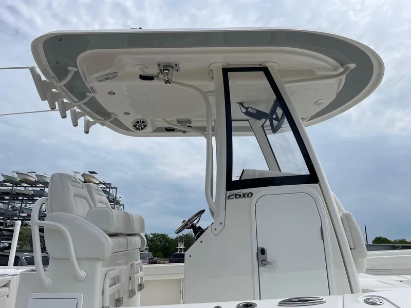 Slide: The Image of 2021 Regulator 26XO boat with T-top and helm station, viewed from the side. - 11
