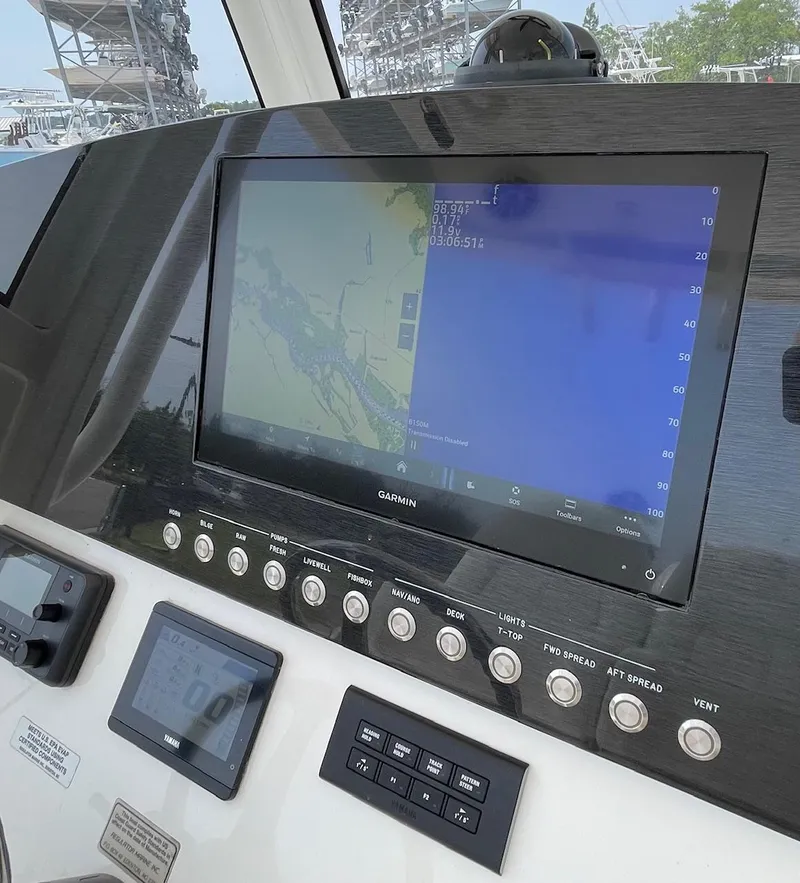 Slide: The Image of 2021 Regulator 26XO boat dashboard with Garmin navigation display and control panel. - 15