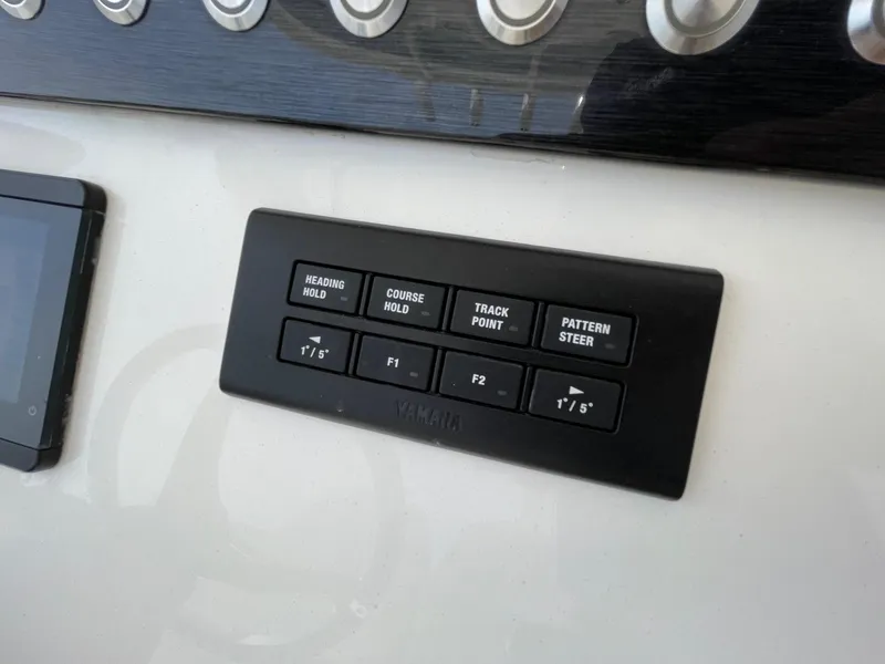 Slide: The Image of Control panel on a 2021 Regulator 26XO boat dashboard with navigation buttons. - 17