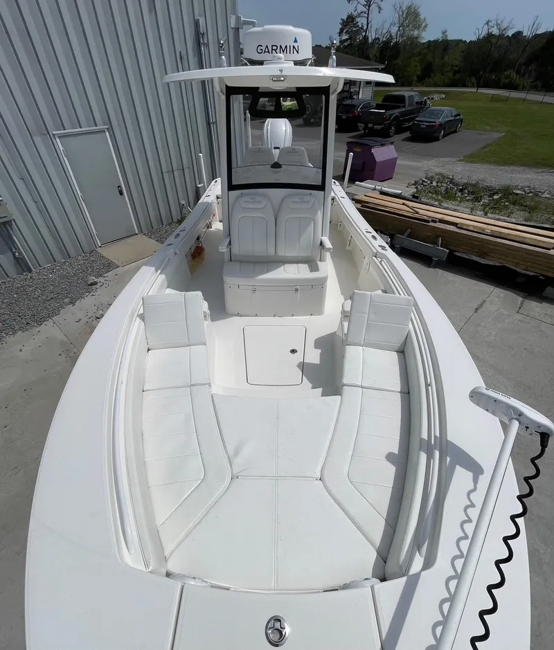 Slide: The Image of 2021 Regulator 26XO boat with spacious deck and Garmin equipment, docked outdoors. - 25