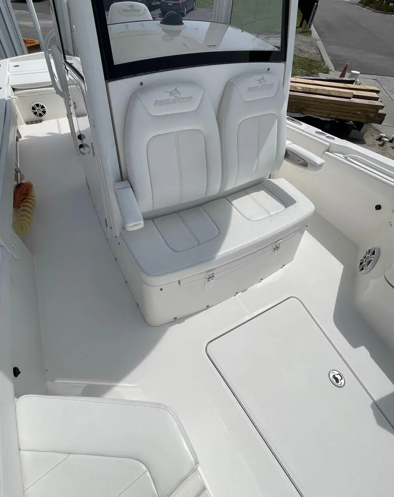 Slide: The Image of 2021 Regulator 26XO boat interior with white seating and console. - 26
