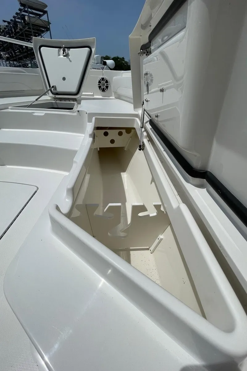 Slide: The Image of 2021 Regulator 26XO boat storage compartment with open hatch, showcasing spacious interior design. - 28