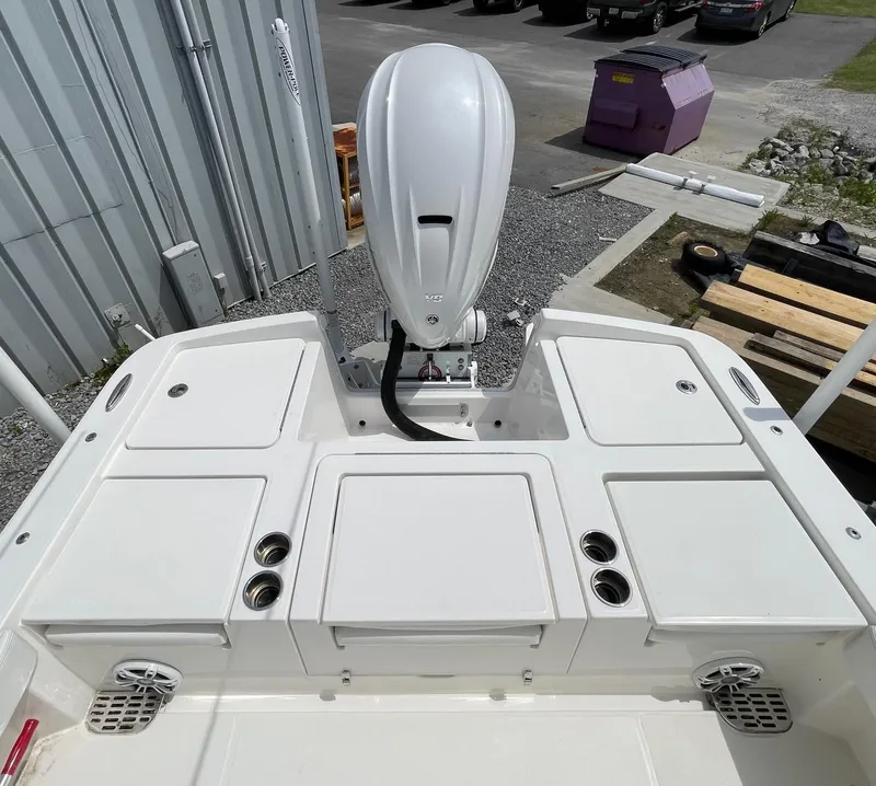 Slide: The Image of 2021 Regulator 26XO boat stern with outboard motor and storage compartments. - 29