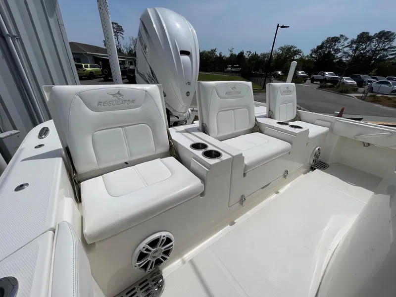 Slide: The Image of 2021 Regulator 26XO boat interior with white seating and cup holders. - 30