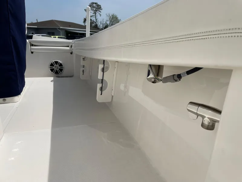 Slide: The Image of 2021 Regulator 26XO boat interior, featuring sleek white design and stainless steel fixtures. - 33